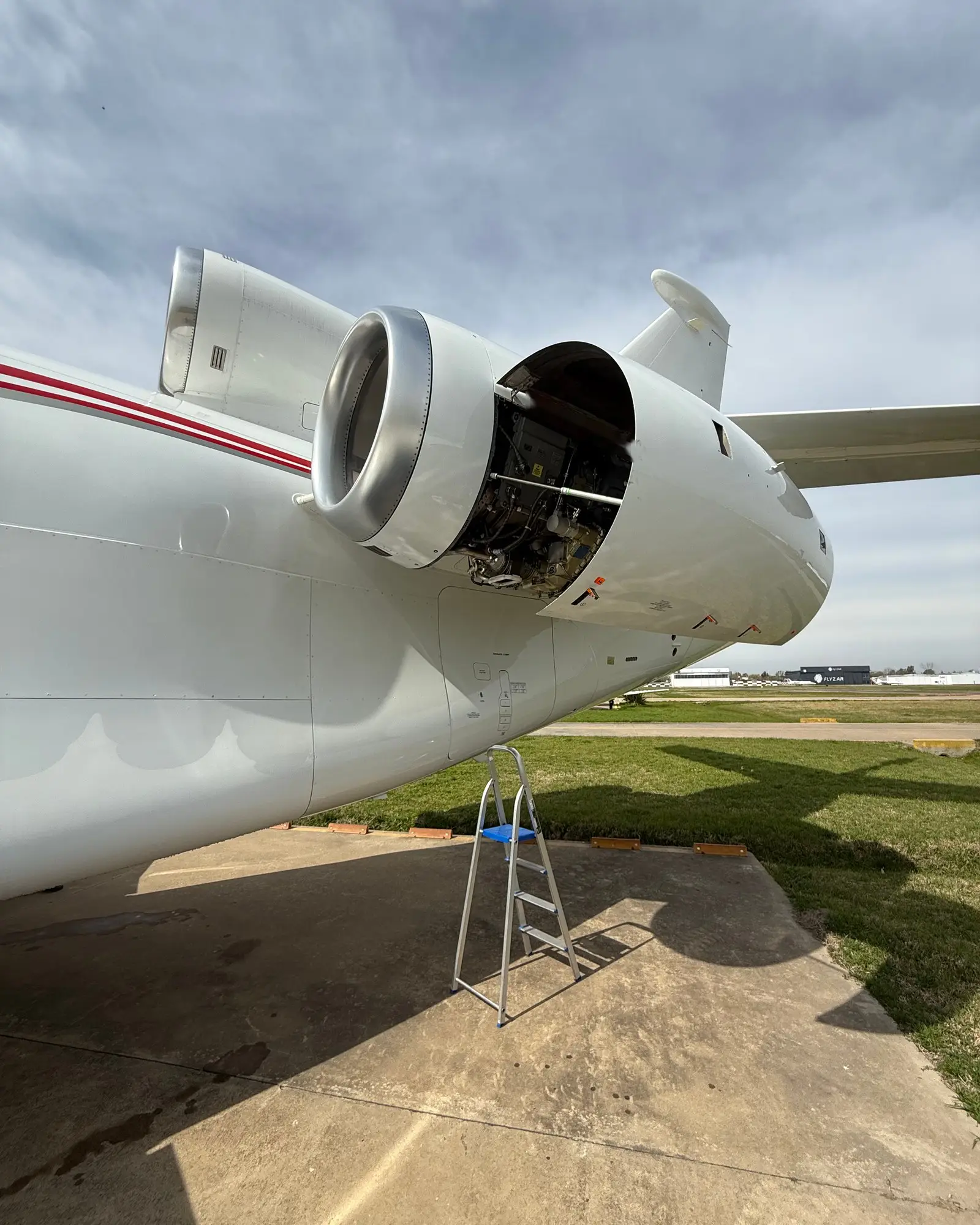 Business jet engine with its cowling open for inspection at Ezeiza